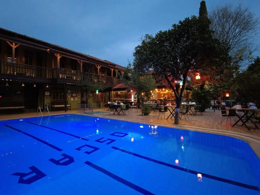 Seasonal outdoor swimming pool with loungers at Oscar Boutique Hotel